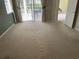Main bedroom with large windows, patio access, and neutral carpeting at 4314 Live Oak Blvd, Palm Harbor, FL 34685