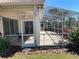 Expansive screened patio with dining and lounge areas, perfect for enjoying the outdoors with lush landscape views at 4314 Live Oak Blvd, Palm Harbor, FL 34685