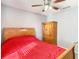 Cozy bedroom featuring light wood furnishings and a ceiling fan for added comfort at 4441 Fieldview Cir, Wesley Chapel, FL 33545