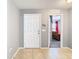 A bright white front door with a six-panel design greets visitors, accented by neutral wall colors and ceramic tile flooring at 4441 Fieldview Cir, Wesley Chapel, FL 33545