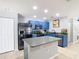 Kitchen with stainless steel appliances, blue cabinets, and island with white countertop at 4441 Fieldview Cir, Wesley Chapel, FL 33545