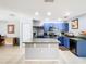 Modern kitchen with an island, stainless steel appliances, blue cabinets, and tile flooring, providing a sleek and functional design at 4441 Fieldview Cir, Wesley Chapel, FL 33545