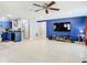 Open living area flows seamlessly with a modern kitchen featuring blue cabinets and a spacious layout at 4441 Fieldview Cir, Wesley Chapel, FL 33545