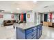 Spacious living room featuring an island with blue cabinetry that seamlessly connects to the living area at 4441 Fieldview Cir, Wesley Chapel, FL 33545