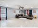Spacious living room with tile flooring, large sectional, and window views, perfect for entertaining and relaxation at 4441 Fieldview Cir, Wesley Chapel, FL 33545