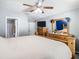 Bedroom features wood furniture, ceiling fan, and view into ensuite bathroom at 4441 Fieldview Cir, Wesley Chapel, FL 33545