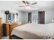 Bright main bedroom featuring wood furniture, neutral walls, ceiling fan, and natural light at 4441 Fieldview Cir, Wesley Chapel, FL 33545