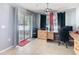 Bright home office with tile floors, wood desk, and sliding glass door to the outside at 4441 Fieldview Cir, Wesley Chapel, FL 33545