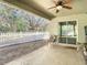 A covered outdoor patio with a view of the fenced-in backyard through a sliding glass door at 4441 Fieldview Cir, Wesley Chapel, FL 33545