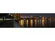 Night view of the city skyline with buildings lit up, bridge, and light reflections on the water, creating a vibrant urban scene at 5231 Bayshore Blvd # 10, Tampa, FL 33611