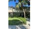 Well-maintained townhome with tan facade, dark shutters, and a lush green lawn and manicured bushes at 5231 Bayshore Blvd # 10, Tampa, FL 33611