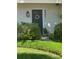 Inviting front entrance with dark door, white trim and floral wreath, surrounded by manicured landscaping at 5231 Bayshore Blvd # 10, Tampa, FL 33611