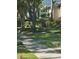 Lush front yard with mature trees and meticulously manicured shrubs along a sidewalk in a quiet neighborhood at 5231 Bayshore Blvd # 10, Tampa, FL 33611