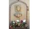 Orchids in pots displayed on a rack with decorative face and shell wall art creating a peaceful and inviting outdoor space at 5231 Bayshore Blvd # 10, Tampa, FL 33611
