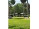 Park featuring a spacious lawn, shady trees, picnic tables, benches, and a paved path for leisurely strolls and outdoor activities at 5231 Bayshore Blvd # 10, Tampa, FL 33611