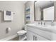 Clean bathroom showcasing a toilet, a large mirror, sink with marble countertop, and a towel rack at 5351 Bridge St # 71, Tampa, FL 33611
