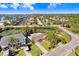 Aerial view of a single-story house with a pond in the backyard in a waterfront community at 5510 Berlin Dr, Port Richey, FL 34668