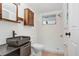 Modern bathroom with unique black sink and a walk-in shower at 5510 Berlin Dr, Port Richey, FL 34668