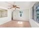 Bright bedroom with tile flooring, a ceiling fan, and a window for natural light at 5510 Berlin Dr, Port Richey, FL 34668