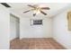 Clean bedroom featuring a ceiling fan, neutral paint, and minimal natural light from a window at 5510 Berlin Dr, Port Richey, FL 34668