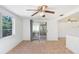 Bonus room with tile flooring, ceiling fan, and sliding glass doors to the backyard at 5510 Berlin Dr, Port Richey, FL 34668