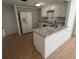 Updated kitchen features white cabinets, granite countertops, stainless steel appliances and an eat in island at 5510 Berlin Dr, Port Richey, FL 34668