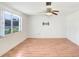 Well-lit living room with hardwood floors and a ceiling fan, ready for relaxation at 5510 Berlin Dr, Port Richey, FL 34668