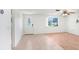 Bright living room featuring tile and wood flooring and an inviting front door at 5510 Berlin Dr, Port Richey, FL 34668