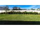 Expansive backyard featuring lush lawn, privacy fence, and manicured hedges creates a private outdoor oasis at 5934 Maidenstone Way, Palmetto, FL 34221