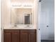 Bathroom featuring a double sink vanity with modern fixtures and a large mirror at 5934 Maidenstone Way, Palmetto, FL 34221