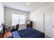 Comfortable bedroom with natural light, dark wood furniture, and a dedicated workspace with a computer at 5934 Maidenstone Way, Palmetto, FL 34221