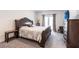 Relaxing bedroom with decorative furniture, plush carpet and access to balcony at 5934 Maidenstone Way, Palmetto, FL 34221