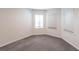Spacious, empty room featuring neutral walls, carpet, and large windows that flood the space with natural light at 5934 Maidenstone Way, Palmetto, FL 34221