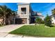 Two-story gray home boasts a well-manicured lawn and attached two-car garage at 5934 Maidenstone Way, Palmetto, FL 34221