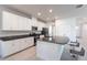 Bright kitchen features white cabinets, stainless appliances and center island at 5934 Maidenstone Way, Palmetto, FL 34221