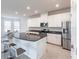 Well-lit kitchen with large island, stainless steel appliances, and dining nook at 5934 Maidenstone Way, Palmetto, FL 34221