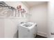 Practical laundry area with a modern washer and dryer, plus wire shelving for storage at 5934 Maidenstone Way, Palmetto, FL 34221