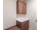 Convenient laundry room featuring a built-in counter, wooden cabinets, and overhead storage at 5934 Maidenstone Way, Palmetto, FL 34221