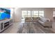 Bright living room features sliding glass doors and a comfortable sectional sofa at 5934 Maidenstone Way, Palmetto, FL 34221