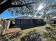Spacious back yard featuring green grass and tree coverage for shade on a sunny day at 6145 103Rd N Ave, Pinellas Park, FL 33782