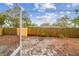 View of the property's spacious backyard, featuring a wooden fence and mature trees at 7030 19Th N Way, St Petersburg, FL 33702