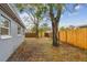 Grassy backyard area features mature trees, offering shade and a tranquil setting at 7030 19Th N Way, St Petersburg, FL 33702