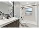Modern bathroom with a black faucet, vanity, decorative mirror, and tiled shower/tub at 7030 19Th N Way, St Petersburg, FL 33702