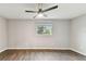 Bright bedroom with a ceiling fan, hardwood floors, and a window providing natural light at 7030 19Th N Way, St Petersburg, FL 33702