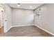 Bright bedroom showcasing wood-look flooring, neutral walls, and natural light from the window at 7030 19Th N Way, St Petersburg, FL 33702