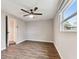 A bright bedroom featuring laminate flooring, a ceiling fan, and natural light at 7030 19Th N Way, St Petersburg, FL 33702