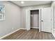 Well-lit bedroom featuring closet, wood-look floors, and fresh neutral paint at 7030 19Th N Way, St Petersburg, FL 33702