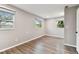 Spacious bedroom featuring wood-look floors, two windows and fresh neutral paint at 7030 19Th N Way, St Petersburg, FL 33702