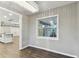 Dining room with wood floors, modern chandelier, and view to the kitchen and backyard at 7030 19Th N Way, St Petersburg, FL 33702
