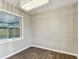 Dining room with wood floors, modern chandelier, and decorative paneled walls at 7030 19Th N Way, St Petersburg, FL 33702